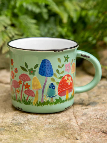 Ceramic mug green with colorful mushrooms. Coffee or tea.
