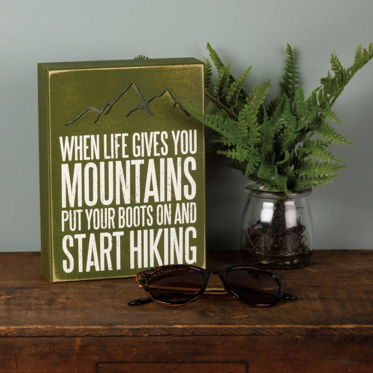 When life gives you mountains put your boots on and start hiking. Green wood sign, laser cut.