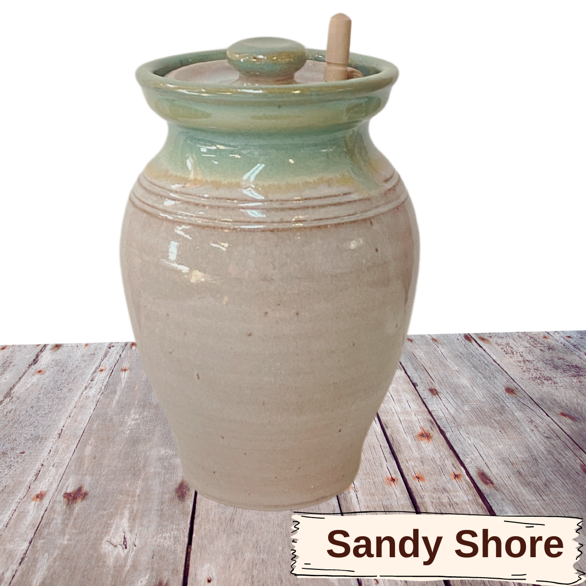 Large honey pot with lid and wooden stir stick. Covered pottery jar with hole in lid.