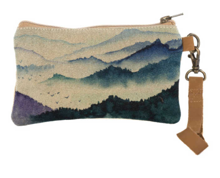 Canvas wristlet with mountain scene. Lined on inside and real leather handle. Cotton canvas artwork on purse