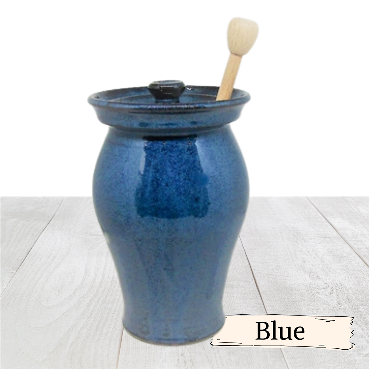 Large honey pot with lid and wooden stick.