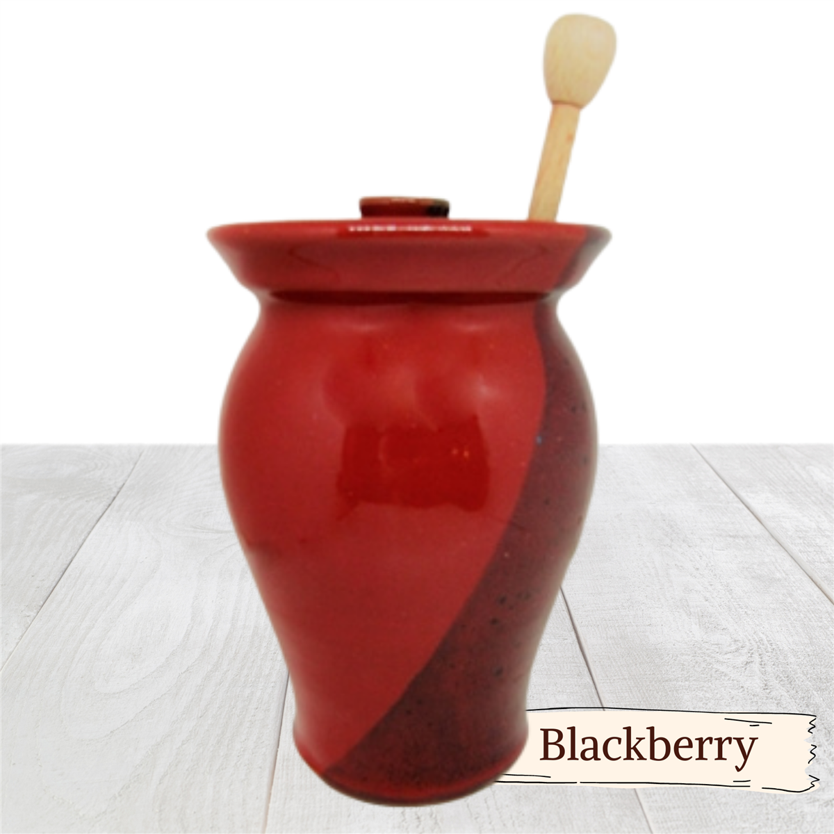 Large honey pot with lid and wooden stick.