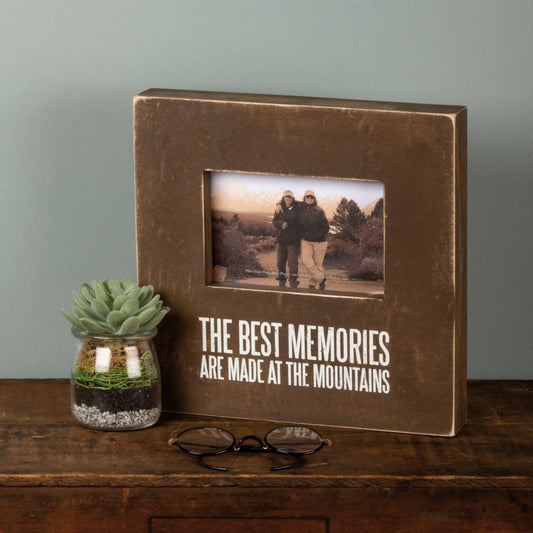Brown photo album with 'The best memories are made at the mountains' 