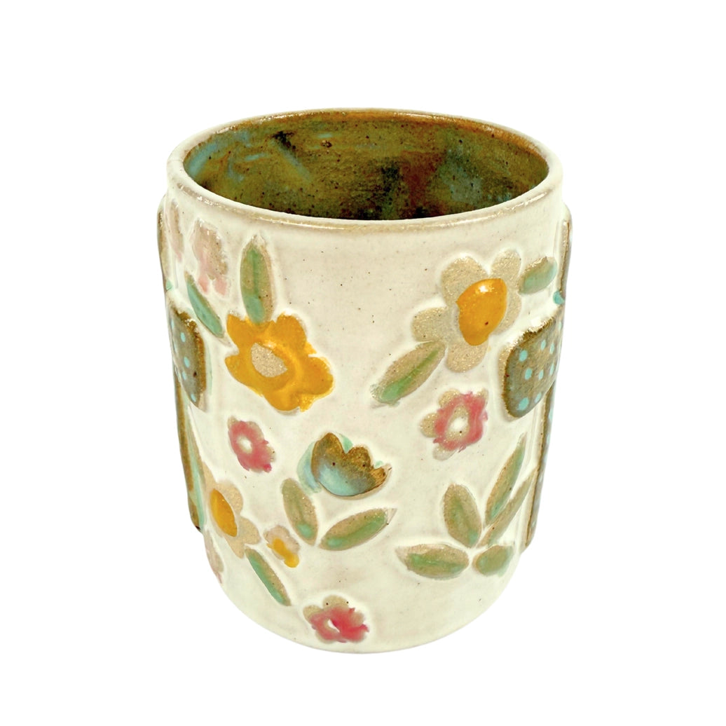 Ceramic mug 16 ounce with teal cross on sides. Neutral colors and flowers